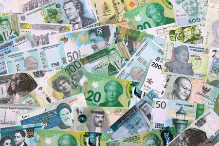Various currencies money bills banknotes. Many cash bills from different countries in big pile close...
