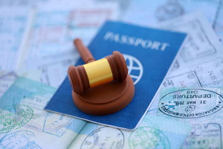 Judgement gavel on passport pages full of colorful stamps after travel and tourism. Border control...