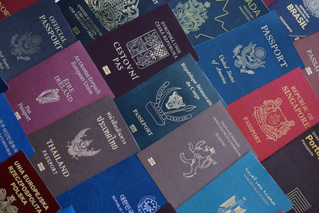 Big amount of passports of various different countries. Covers of expired passports close up. Travel documents for tourismの写真素材