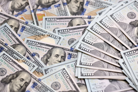 Stack of dollars and cash with a money background. US money and banknotes. Pile of 100 USD bills....