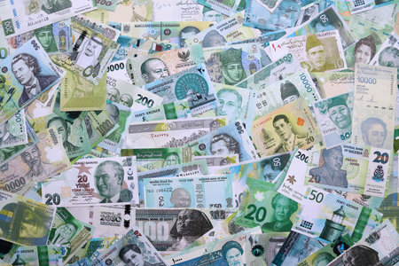Various currencies money bills banknotes in green color. Many cash bills from different countries in...