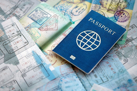 One fictional passport on big amount of passport pages full of colorful stamps after travel and...