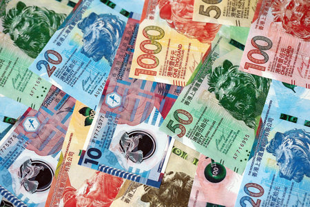 Big pile of Hong Kong dollars money bills banknotes close up. Lots of money of Chinese Hong Kong HKD...