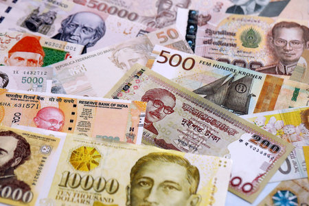 Various currencies money bills banknotes in yellow and orange color. Many cash bills from different...
