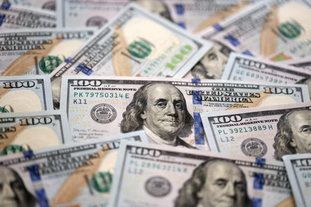 Stack of dollars and cash with a money background. US money and banknotes. Pile of 100 USD bills....