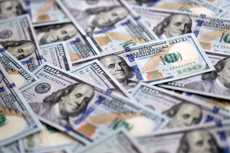 American dollars in one hundred banknotes. Lot of dollars close up. Stack of dollars and cash with a...
