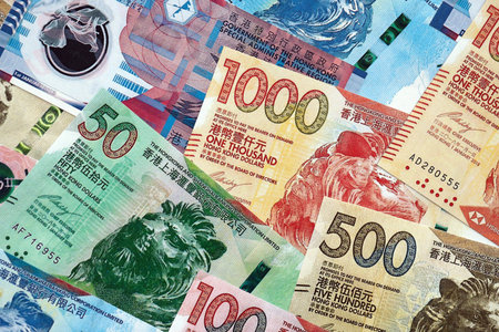 Big pile of Hong Kong dollars money bills banknotes close up. Lots of money of Chinese Hong Kong HKD...