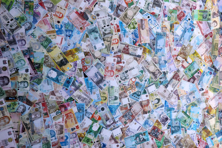 Many banknotes from different countries of the world of different denominations. Big amount of money...