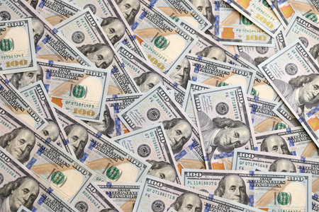 Big pile of new USD hundred dollar bills. Currency of United States of America in big amount. US one...