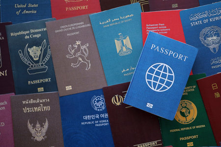 Fictional passport book travel document on big amount of real passport covers of various different...