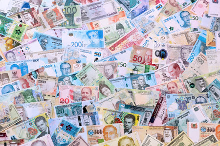 Big amount of money bills of different various currencies and countries. Assortment background of...