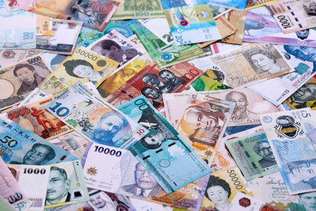 Different banknotes from many currencies of the whole world. Big pile of money bills close upの写真素材
