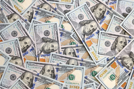 Stack of dollars and cash with a money background. US money and banknotes. Pile of 100 USD bills....