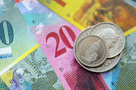 Currency of Switzerland. Banknotes and Swiss franc coins on them. Financial topics in Swiss banking concept.の写真素材