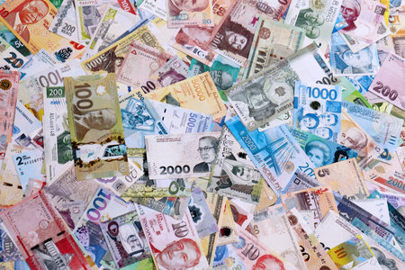 Different money banknotes from many currencies of the whole world. Big pile of money bills close up