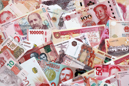 Various currencies money bills banknotes in red color. Many cash bills from different countries in...