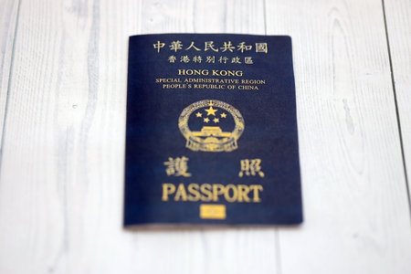 Hong Kong Special Administrative Region HKSAR Passport lies on wooden table background close up....