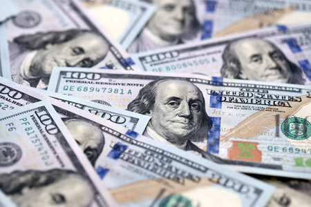 Stack of dollars and cash with a money background. US money and banknotes. Pile of 100 USD bills....