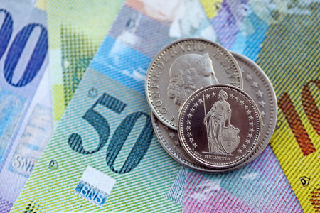 Currency of Switzerland. Banknotes and Swiss franc coins on them. Financial topics in Swiss banking...