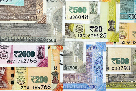 Big pile of Indian Rupees money bills banknotes close up. Lots of money of Indian INR currency cash...