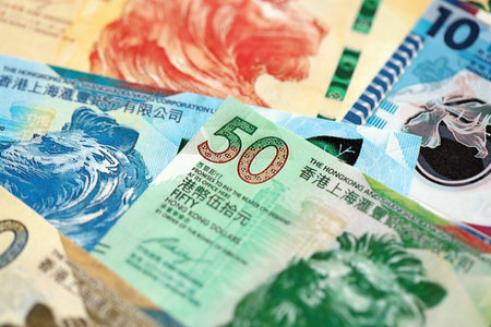Big pile of Hong Kong dollars money bills banknotes close up. Lots of money of Chinese Hong Kong HKD...