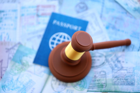 Judgement gavel on passport pages full of colorful stamps after travel and tourism. Border control...