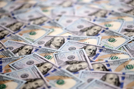 Big pile of new USD hundred dollar bills. Currency of United States of America in big amount. US one...