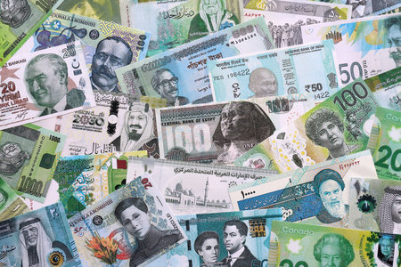 Various currencies money bills banknotes in green color. Many cash bills from different countries in...