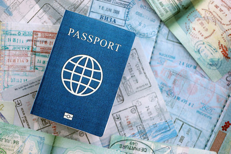 One fictional passport on big amount of passport pages full of colorful stamps after travel and...