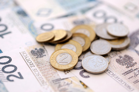 Big amount of polish zloty money banknotes and grosz coins close up. Huge pile of cash of Poland...