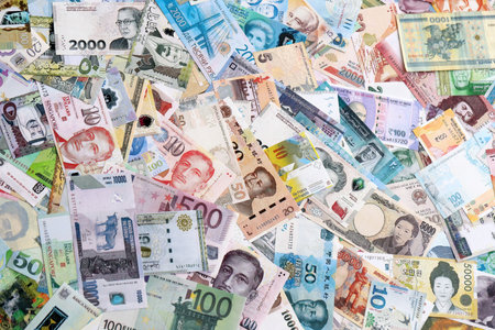 Different banknotes from many currencies of the whole world. Big pile of money bills close up