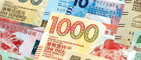 Big pile of Hong Kong dollars money bills banknotes close up. Lots of money of Chinese Hong Kong HKD...
