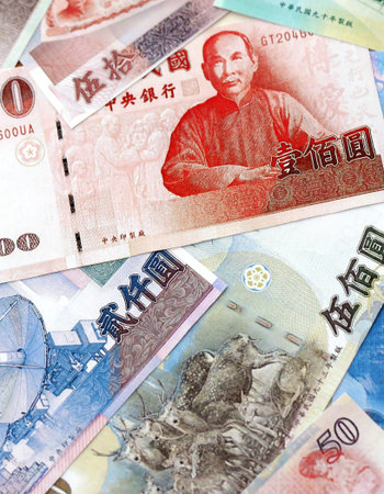 Taiwanese dollar paper banknotes pile on table. Taiwan TWD currency money bills in big amount....