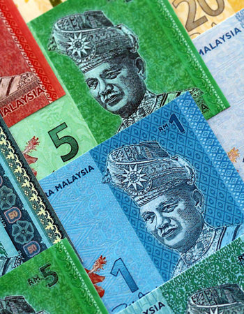 Malaysian ringgit paper banknotes pile on table. Malaysia MYR currency money bills in big amount....