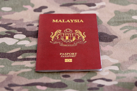 Malaysian passport on table close up. Official identification document book for citizens of Malaysia. Concept of travel and tourismの写真素材