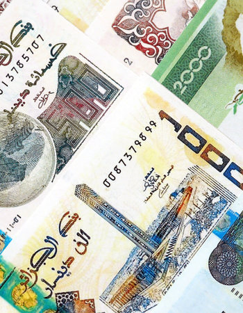 Algerian dinar paper banknotes pile on table. Algeria DZD currency money bills in big amount....