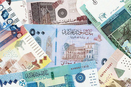 Sudanese pound paper banknotes pile on table. Sudan SDG currency money bills in big amount. Concept...