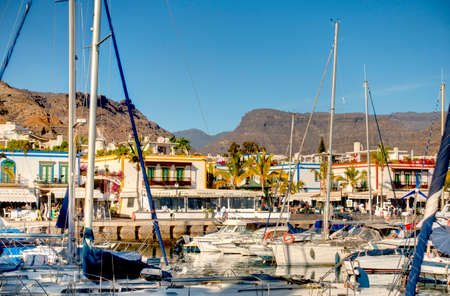 Mogan, Grand Canary Island - February 2020 : picturesque harbour in sunny weather, HDR Image
