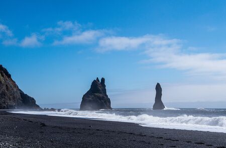 Black sand beach in Iceland sea stacksの写真素材