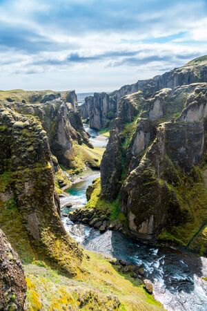 Iceland canyon fjaÃ°rÃ¡rgljÃºfur with river flowing through itの写真素材
