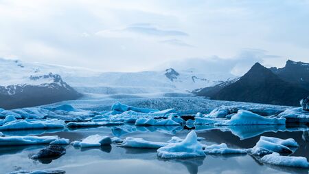 Glacier lake with icebergs with mountain and glacier in the background in Fjallsarlon, Icelandの写真素材