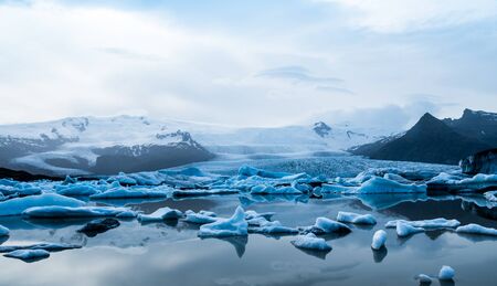 Glacier lake with icebergs with mountain and glacier in the background in Fjallsarlon, Icelandの写真素材