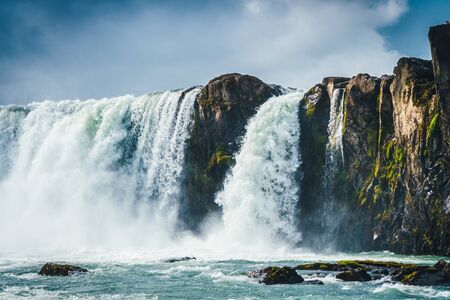Godafoss waterfall in Iceland with cloudy skyの写真素材
