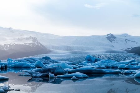 Glacier lake with icebergs with mountain and glacier in the background in Fjallsarlon, Icelandの写真素材