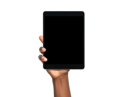 The image shows a hand holding a black tablet device against a plain white background. The tablet screen is turned off, and the hand is positioned in such a way that the fingers are visible on the sides of the tablet. The image focuses solely on the hand and the tablet, emphasizing the simplicity and minimalism of the scene.の素材