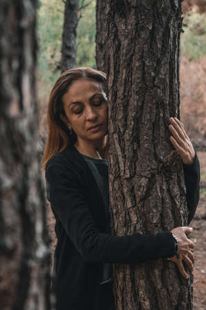 Portrait of a woman in a forest during autumn.の写真素材