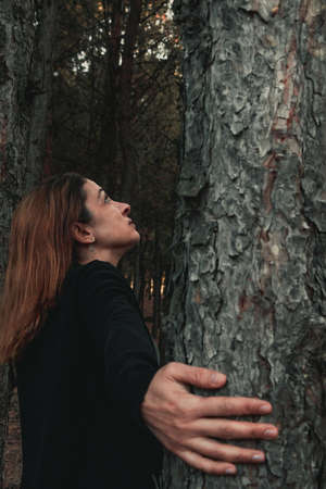 Portrait of a woman in a forest during autumn.