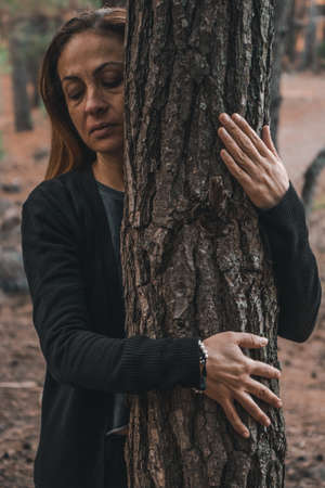 Portrait of a woman in a forest during autumn.
