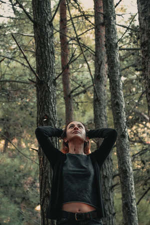 Portrait of a woman in a forest during autumn.の写真素材