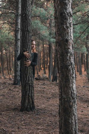 Portrait of a woman in a forest during autumn.の写真素材